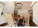 The dining room features a light fixture and a rustic wood table with custom chairs at 10044 E 146Th Pl, Brighton, CO 80602