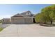 An eye-level exterior shot of the home showing the brickwork and the three-car garage at 10044 E 146Th Pl, Brighton, CO 80602