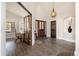 A spacious foyer featuring beautiful flooring, statement lighting, and an arched doorway at 10044 E 146Th Pl, Brighton, CO 80602