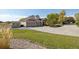 A well-manicured lawn with a charming outbuilding accompanies this home with a three-car garage at 10044 E 146Th Pl, Brighton, CO 80602