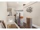 Upstairs hallway with wooden railing, modern decor, and views into other rooms at 10044 E 146Th Pl, Brighton, CO 80602