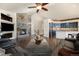 A spacious living room with fireplace and open floor plan leading to the kitchen at 10044 E 146Th Pl, Brighton, CO 80602