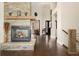 Bright living room features a stone fireplace, hardwood floors, and great natural light at 10044 E 146Th Pl, Brighton, CO 80602