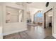 A living room featuring a stone fireplace, hardwood floors, and many large windows at 10044 E 146Th Pl, Brighton, CO 80602