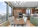 Inviting dining area with large windows offering a view and stylish light fixture at 283 Huntley Ct, Castle Pines, CO 80108