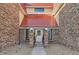 Front entrance featuring brick pillars and red metal roof at 14720 E Kentucky Dr # 625, Aurora, CO 80012