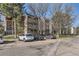 Multi-story condo building with balconies and parking under mature trees at 14720 E Kentucky Dr # 625, Aurora, CO 80012