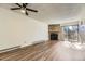 Open living room with fireplace and sliding doors to a balcony at 14720 E Kentucky Dr # 625, Aurora, CO 80012