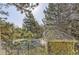 Community pool area surrounded by mature trees and a charming pool house structure at 14720 E Kentucky Dr # 625, Aurora, CO 80012