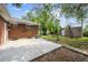 Spacious backyard featuring a brick house, a concrete patio, and a storage shed on a sunny day at 10452 Washington Way, Northglenn, CO 80233