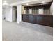Finished basement featuring wet bar, gray carpet, and access to other rooms at 10452 Washington Way, Northglenn, CO 80233