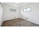 Inviting carpeted bedroom with white walls and two windows providing bright natural light at 10452 Washington Way, Northglenn, CO 80233