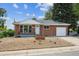 Charming brick home with a well-maintained front yard and attached one-car garage at 10452 Washington Way, Northglenn, CO 80233