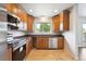 Well-appointed kitchen featuring stainless steel appliances and neutral tile flooring at 10452 Washington Way, Northglenn, CO 80233