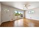 Bright living room features hardwood floors, large windows, and a ceiling fan at 10452 Washington Way, Northglenn, CO 80233