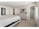 Spacious bedroom with a walk-in closet, neutral decor, and plush carpeting at 1815 Grove St, Denver, CO 80204