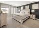 Cozy bedroom featuring a decorative headboard, bedside tables, and natural light at 1815 Grove St, Denver, CO 80204