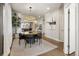 Bright dining room with modern light fixture, art on the wall, and view into the kitchen at 1815 Grove St, Denver, CO 80204