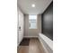 Well-lit entryway with hardwood floors, a white front door, and a bench at 1815 Grove St, Denver, CO 80204