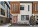 Inviting home exterior featuring a vibrant colored front door, modern design, and cozy seating area at 1815 Grove St, Denver, CO 80204