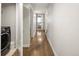 Long hallway with hardwood floors and a laundry closet at 1815 Grove St, Denver, CO 80204