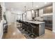 A sleek kitchen has an island with barstools and stainless appliances, with the dining room visible at 1815 Grove St, Denver, CO 80204