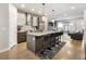 Modern kitchen with stainless steel appliances, a kitchen island with bar stool seating, and hardwood floors at 1815 Grove St, Denver, CO 80204