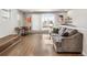 Bright living room featuring hardwood floors, modern furniture, and sliding glass doors leading to the outside at 1815 Grove St, Denver, CO 80204