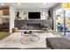 Living room with fireplace, TV, modern decor, and sliding glass doors to an outdoor space at 1815 Grove St, Denver, CO 80204