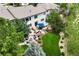 Aerial view of the backyard showcasing the patio, fire pit, lush lawn, and mature trees, creating a private oasis at 6095 S Oswego St, Greenwood Village, CO 80111