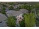 Aerial view of a neighborhood showcasing a house with a backyard featuring a patio and manicured lawn at 6095 S Oswego St, Greenwood Village, CO 80111