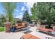 Inviting back patio with lounge seating, fire pit, and lush landscaping, perfect for outdoor entertaining at 6095 S Oswego St, Greenwood Village, CO 80111