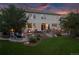 Backyard featuring patio, fire pit, lush lawn, and mature trees, perfect for outdoor living and entertaining at 6095 S Oswego St, Greenwood Village, CO 80111