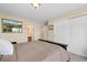 Bedroom featuring an en suite bath and double-door closet at 6095 S Oswego St, Greenwood Village, CO 80111