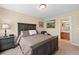 Comfortable bedroom with a full bath, dark wood furniture, and neutral walls at 6095 S Oswego St, Greenwood Village, CO 80111