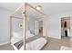 Cozy bedroom features a full sized bed and access to a walk-in closet at 6095 S Oswego St, Greenwood Village, CO 80111