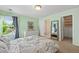 Bright bedroom with large window, walk-in closet, ensuite bathroom, and stylish decor at 6095 S Oswego St, Greenwood Village, CO 80111