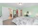 This bedroom provides easy access to both an ensuite bathroom and a walk-in closet at 6095 S Oswego St, Greenwood Village, CO 80111
