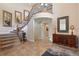 Grand foyer features soaring ceilings, staircase with iron railings, and elegant tile flooring at 6095 S Oswego St, Greenwood Village, CO 80111
