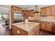 Gourmet kitchen featuring a large island, granite countertops, stainless steel appliances, and ample cabinet space at 6095 S Oswego St, Greenwood Village, CO 80111