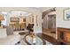 Open concept living space showcases hardwood floors, dining area, staircase, and great natural light at 6095 S Oswego St, Greenwood Village, CO 80111