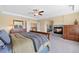 Main bedroom featuring a fireplace and a large dresser with a mirror at 6095 S Oswego St, Greenwood Village, CO 80111
