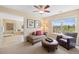 Comfortable sitting area features a ceiling fan, couch, coffee table, and chair at 6095 S Oswego St, Greenwood Village, CO 80111