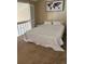Cozy bedroom features a comfortable bed, world map wall art and sunny windows at 4899 S Dudley St # K18, Littleton, CO 80123