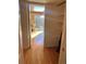 Hallway leading to a bright office space, with ample closet storage and hardwood floors at 4899 S Dudley St # K18, Littleton, CO 80123