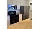 Kitchen features stainless steel refrigerator, range, and built in microwave plus in-unit washer and dryer at 4899 S Dudley St # K18, Littleton, CO 80123