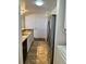 Galley kitchen with stainless steel appliances, neutral cabinets, and tile flooring at 4899 S Dudley St # K18, Littleton, CO 80123