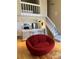 Bright living space featuring an open kitchen, staircase, and a unique red lounge chair at 4899 S Dudley St # K18, Littleton, CO 80123
