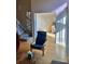 Inviting space with modern chair, open doorway, and staircase leading to the upper level at 4899 S Dudley St # K18, Littleton, CO 80123