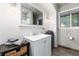 Well-lit bathroom features a modern vanity, a large mirror, and a window with natural light at 159 Lake Rd, Idaho Springs, CO 80452